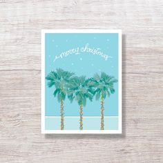 three palm trees with the words merry christmas written in white on blue and green background