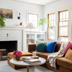 a living room filled with furniture and a fire place in front of a white fireplace