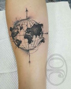 a black and white world map tattoo on the right arm with an arrow in it