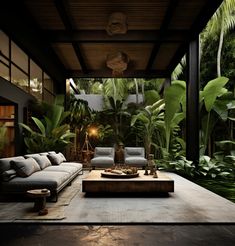 a living room filled with furniture and lots of plants in the back ground, surrounded by greenery