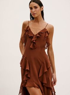 The stunning Brown Silvia Riffle Maxi Dress is an elegant piece that features a V neckline with adjustable shoulder straps for the perfect fit. Flattering ruffle trim throughout gracefully cascades down the hem, finished with a thigh slit and maxi hem. Details: Polyester Lined Made in Brazil V neckline Adjustable straps Resort Wear Dresses, Beach Swimsuit, Ruffled Maxi Dress, Swimwear Girls, V Neckline, Resort Wear, Ruffle Trim, Womens Swimwear, Shoulder Straps