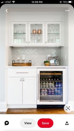 a kitchen with white cabinets and an appliance on the phone showing what's in the refrigerator