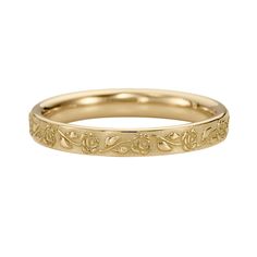 a yellow gold wedding band with an intricate design