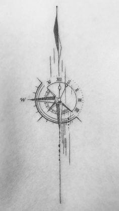 a compass tattoo on the back of a woman's shoulder