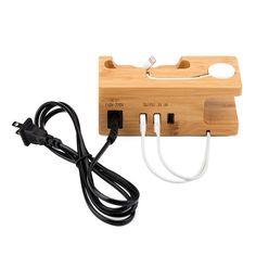 an electric outlet plugged into a wooden box with two wires attached to the wall