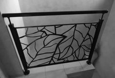 a black and white photo of a hand rail in a bathroom