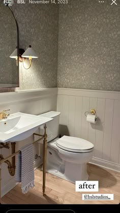 a white toilet sitting next to a sink under a mirror in a bathroom with wooden floors