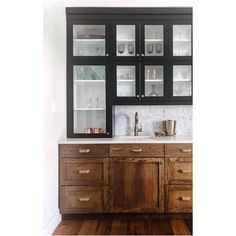 a kitchen with black cabinets and white counter tops