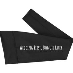 the wedding first, donuts later logo is printed on black sweatpants with white lettering