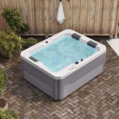 a hot tub sitting on top of a brick patio