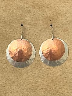 "Hammered and domed sterling/copper dangle earrings. Large circle is 1 1/4\" and small is 1\" diameter. 24 ga metal so super light. Stainless steel flat fishhook wire." Nickel-free Copper Hoop Earrings, Hammered Copper Drop Earrings, Hammered Copper Round Hoop Earrings, Hammered Rose Gold Sterling Silver Hoop Earrings, Rose Gold Hammered Sterling Silver Hoop Earrings, Rose Gold Hammered Metal Earrings, Nickel-free Metal Round Disc Earrings, Hand Forged Rose Gold Sterling Silver Earrings, Hammered Rose Gold Copper Earrings