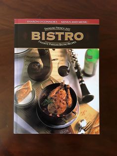 a cookbook sitting on top of a wooden table