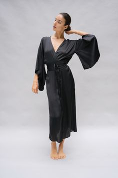 The Nerine Robe is an elegant wardrobe essential, showcasing an artful drape and dramatic sleeves. A tie waist belt accentuates your silhouette and the absence of belt loops allow for a versatile kimono jacket option. The Nerine robe is an elevated choice for morning and evening rituals, as well as any moment in between, whether you're at home or in a faraway destination. Chic Wrap Kimono For Daywear, Chic Kimono With Tie Waist And Kimono Sleeves, Elegant V-neck Belted Robe, Fitted Wrap Robe, Chic Wrap Kimono For Brunch, Elegant Fitted Wrap Kimono, Elegant Wrap Robe With Tie Waist, Chic Long Sleeve Kimono With Tie Waist, Chic Wrap Kimono For Parties