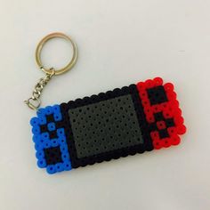 a keychain made out of legos is shown with an image of a gameboy