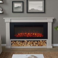 a living room with a fire place and pictures on the wall