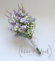 purple and white flowers are tied together with twine