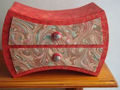 an artistically designed wooden box with two knobs