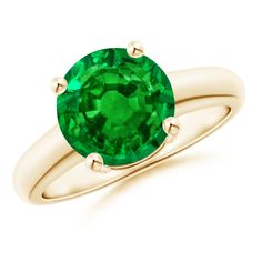 a gold ring with an emerald stone in the center