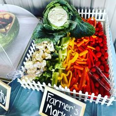 there are many different types of vegetables in the basket on the table, including lettuce and carrots