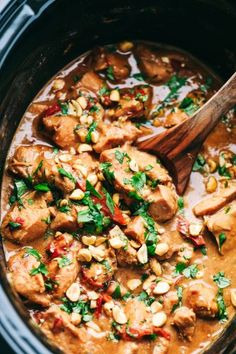 a slow cooker filled with meat and vegetables