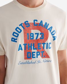 Our Mens Roots Athletic Dept. T-shirt is made for effortless, everyday wear. Crafted in comfy organic cotton jersey, it also features a cool printed graphic. 100% organic cotton jersey Classic fit Ribbed neck Front chest graphics Heritage clip label ABOUT 100% cotton jersey SIZE & FIT The model is wearing a size medium Model Measurements: Height: 6'1 Chest: 39 Waist: 32 ; suit size: 40-R; neck: 15.5 ; sleeve: 34.5 CLASSIC FIT Our Classic Fit is made for comfort. Not too close to the body, but not too loose. LOOK AFTER ME Reverse garment before washing or ironing Machine wash cold, gentle cycle with like colours No bleach Tumble dry low - low iron Do not iron decoration Do not dry clean | Roots Men's Athletic Dept. T-Shirt in Snowdrift White Athletic Dept Shirts, Graffiti Tshirt, Gloves Dress, Sweat Sets, Merch Design, Ironing Machine, Newborn Accessories, Kids School Backpack, Branding Inspo