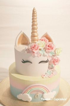 there is a cake decorated with flowers and a unicorn's face on top of it