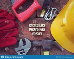 happy labor day written in scrabble letters with construction tools