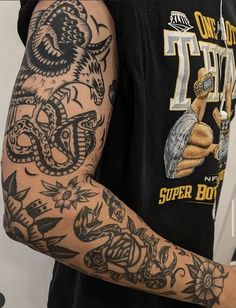 a man with tattoos on his arm and shoulder