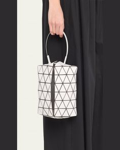 BAO BAO ISSEY MIYAKE "Torsos" top handle bag in PVC, polyester, and nylon/polyamide    Top handle     Center zip closure     Interior, one slip pocket     Lining: Nylon    Approx. 7.9"H x 7.5"W x 4.5"D    Item Weight (Lbs.): 0.5    Made in Japan Top Handle Nylon Bag With Removable Pouch, Nylon Top Handle Bag With Removable Pouch, Evening Nylon Shoulder Bag With Top Handle, Evening Nylon Top Handle Shoulder Bag, Modern White Box Bag With Handles, Modern White Bucket Box Bag, Nylon Top Handle Bag With Detachable Handle, White Nylon Bags With Double Handle, Modern White Nylon Shoulder Bag