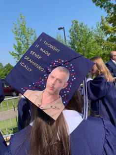 a man wearing a graduation cap with the image of himself on it