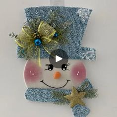 a christmas ornament with a snowman face on it's head and a star