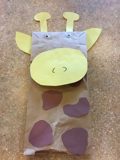 a brown paper bag with purple hearts and a giraffe's head on it