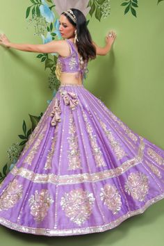 Peri peri purple raw silk lehenga with attached cancan and panels embroidered in sequins, zardozi and applique floral embroidery. Comes with embellished padded blouse and pink organza dupatta.
Component: 3
Pattern: Embroidery
Type Of Work: Sequins, Zardozi, Applique
Neckline: V Neck
Sleeve Type: Sleeveless
Fabric: Lehenga and Blouse: Raw Silk, Dupatta: Organza
Color: Purple
Other Details: 
Attached lining
Sequins, zardozi and applique work
Occasion: Destination Wedding - Aza Fashions Purple Sharara With Gota Work For Party, Purple Cutdana Lehenga For Party, Purple Dola Silk Lehenga With Gota Work, Purple Lehenga With Gota Work In Dola Silk, Purple Dola Silk Lehenga For Parties, Semi-stitched Purple Choli With Gota Work, Purple Gota Work Dresses For Navratri, Purple Lehenga With Gota Work For Party, Designer Purple Choli With Gota Work