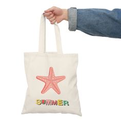 "Dive into the magic of summer with our Starfish Summer Tote Bag, featuring a captivating pink starfish illustration and the word \"summer\" written below in a delightful array of colorful letters. This canvas tote captures the enchantment of the season, allowing you to carry the vibrant hues and carefree spirit of summer wherever you venture. 🌟 Key Features: * Playful Starfish: The charming pink starfish illustration brings the beach to life and adds a touch of whimsy to your style, making you feel like you're seaside all year round. * Colorful Typography: The word \"summer\" is elegantly spelled out in an array of vivid and joyful colors, reflecting the vibrant energy of the season. * Durable Canvas: Crafted from sturdy canvas material, this tote bag is designed to accompany you on your Pink Reusable Beach Bag, Casual Reusable Canvas Bag For Summer, Summer Travel Reusable Canvas Bag, Pink Canvas Bag For Summer Vacation, Summer Canvas Gift Bag, Summer Beach Bag With Letter Print, Summer Canvas Bag With Letter Print, Summer Beach Bag As A Gift, Casual Reusable Beach Bag For Summer