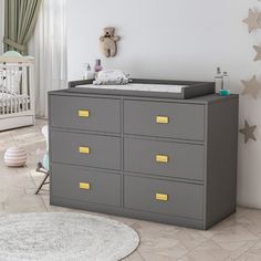 a baby's room with a dresser and crib