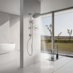 a bathroom with a large window and a shower head next to the bathtub is shown