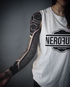 a woman with tattoos on her arm and arms is holding onto a white sleeveless shirt that says nerofu tattoo