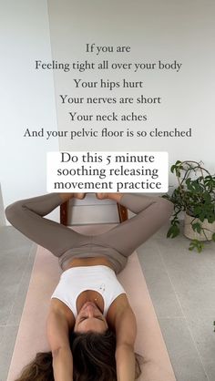 a woman is doing yoga on the floor with her back to the camera and arms behind her head