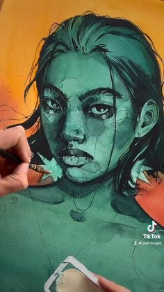 a person is drawing on a piece of paper with colored pencils and watercolor