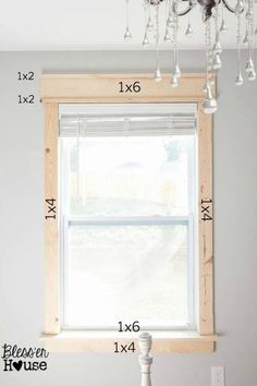 a window with measurements for the height of it in front of a chandelier