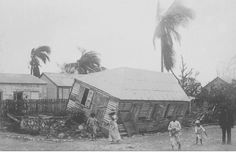 an old black and white photo of people standing in front of a house that has been destroyed