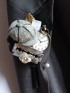 a pocket watch and keychain made to look like an old basketball ball is sitting in the pocket of a man's suit