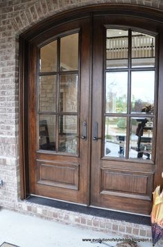 two wooden doors with glass on brick building