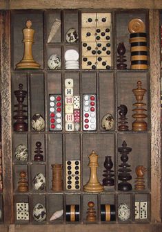 a wooden box filled with lots of different types of chesss and checkers in it