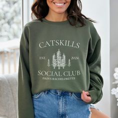 This Camp Bachelorette sweatshirt is the perfect way to gear up for an unforgettable bachelorette experience. It's not just a garment; it's your ticket to a weekend of outdoor fun, laughter, and memories that will last a lifetime. It makes the perfect companion for your camp-themed bachelorette party. Whether you're roasting marshmallows under the stars or embarking on a scenic hike in Lake Tahoe, this cabin crewneck is your go-to choice for celebrating amidst the beauty of nature. Ideal for any Cabin Girls Trip, Bachelorette Merch, Themed Bachelorette, Roasting Marshmallows, Bachelorette Party Themes, Under The Stars, Lake Tahoe, Outdoor Fun, Marshmallows