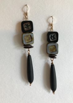 EARRINGS:  Black and grey sophistication in square Czech Picasso  high quality beads known for their vibrant colors!  Even this grey commands respect!  Black matte teardrop beads in a saturated endless black.  Earring wires are 14k gold filled (filled is 100 times thicker than plated!). Black Rectangular Beaded Jewelry, Handmade Black Contemporary Earrings, Contemporary Handmade Black Earrings, Grey Earrings, Black Earring, Gray Earrings, Earring Wires, Teardrop Beads, Earrings 3