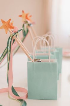 small bags with handles and ribbons tied to them