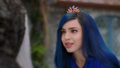 a woman with blue hair wearing a tiara