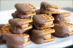 a white plate topped with chocolate covered pretzels and marshmallow waffles