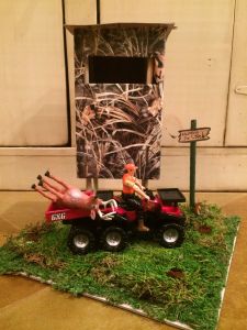 there is a toy truck with two people on it in front of a tree stand